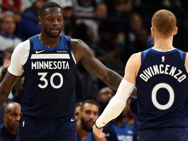 MINNEAPOLIS, MINNESOTA - OCTOBER 26: Julius Randle #30 interacts with Donte DiVincenzo #0 of the Minnesota Timberwolves in the third quarter of the home opener against the Toronto Raptors at Target Center on October 26, 2024 in Minneapolis, Minnesota. The Timberwolves defeated the Raptors 112-101.