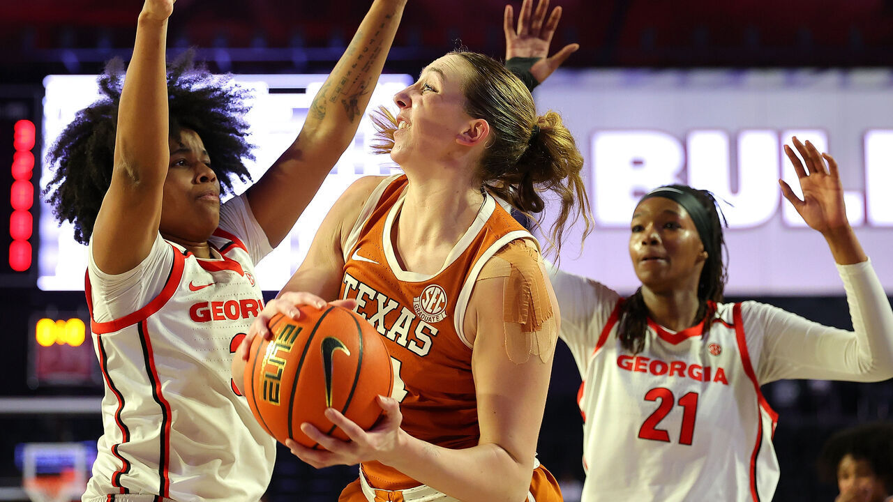 ATHENS, GEORGIA - FEBRUARY 24: Taylor Jones #44 of the Texas Longhorns is defended by Mia Woolfolk #33 of the Georgia Lady Bulldogs during the first quarter at Stegeman Coliseum on February 24, 2025 in Athens, Georgia.