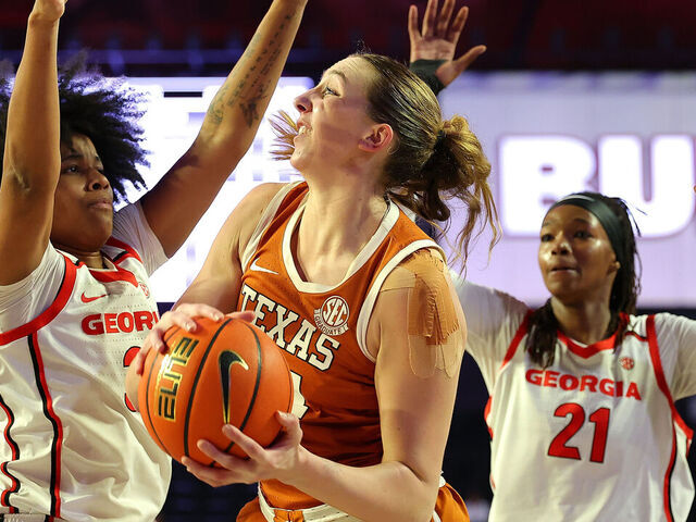 ATHENS, GEORGIA - FEBRUARY 24: Taylor Jones #44 of the Texas Longhorns is defended by Mia Woolfolk #33 of the Georgia Lady Bulldogs during the first quarter at Stegeman Coliseum on February 24, 2025 in Athens, Georgia.
