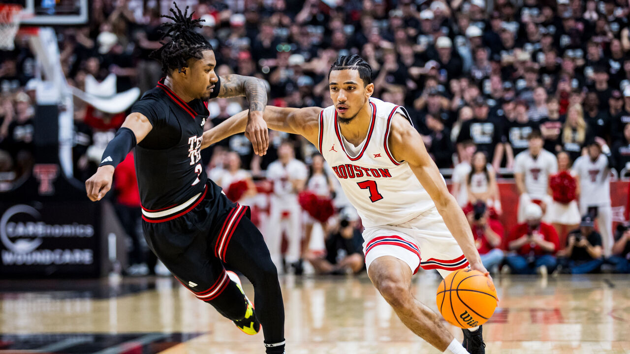 LUBBOCK, TEXAS - FEBRUARY 24: Milos Uzan #7 of the Houston Cougars handles the ball against Elijah Hawkins #3 of the Texas Tech Red Raiders during the first half of the game at United Supermarkets Arena on February 24, 2025 in Lubbock, Texas.