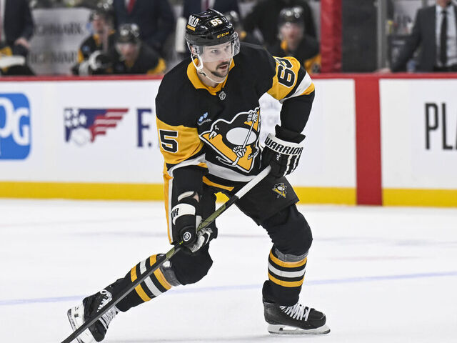 PITTSBURGH, PA - FEBRUARY 22: Pittsburgh Penguins defenseman Erik Karlsson (65) shoots the puck during the first period in the NHL game between the Pittsburgh Penguins and the Washington Capitals on February 22, 2025, at PPG Paints Arena in Pittsburgh, PA.