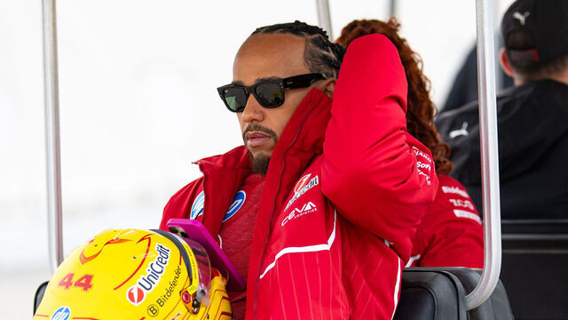 BAHRAIN, BAHRAIN - FEBRUARY 26: Lewis Hamilton of Great Britain and Ferrari travels via buggy in the paddock during day one of F1 Testing at Bahrain International Circuit on February 26, 2025 in Bahrain, Bahrain.