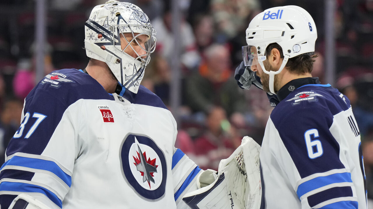 OTTAWA, CANADA - FEBRUARY 26: Colin Miller #6 of the Winnipeg Jets congratulates Connor Hellebuyck #37 after their teams' 4-1 win against the Ottawa Senators at Canadian Tire Centre on February 26, 2025 in Ottawa, Ontario, Canada.