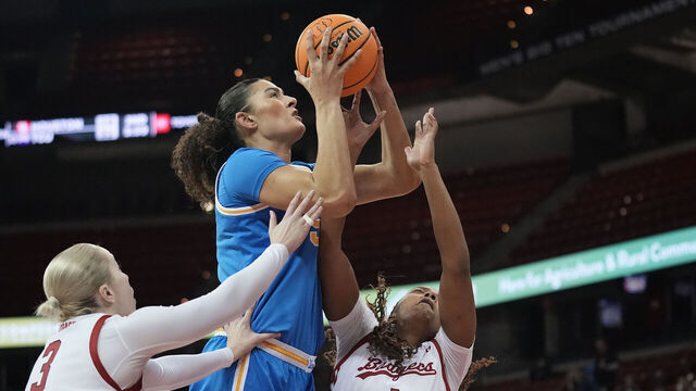 MADISON, WISCONSIN - FEBRUARY 26: Lauren Betts #51 of the UCLA Bruins shoots against Tess Myers #3 and Carter McCray #1 of the Wisconsin Badgers during the first quarter at Kohl Center on February 26, 2025 in Madison, Wisconsin.