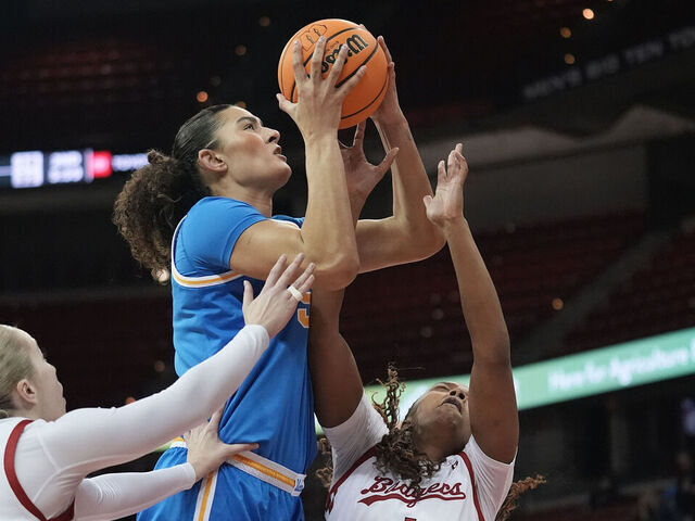 MADISON, WISCONSIN - FEBRUARY 26: Lauren Betts #51 of the UCLA Bruins shoots against Tess Myers #3 and Carter McCray #1 of the Wisconsin Badgers during the first quarter at Kohl Center on February 26, 2025 in Madison, Wisconsin.