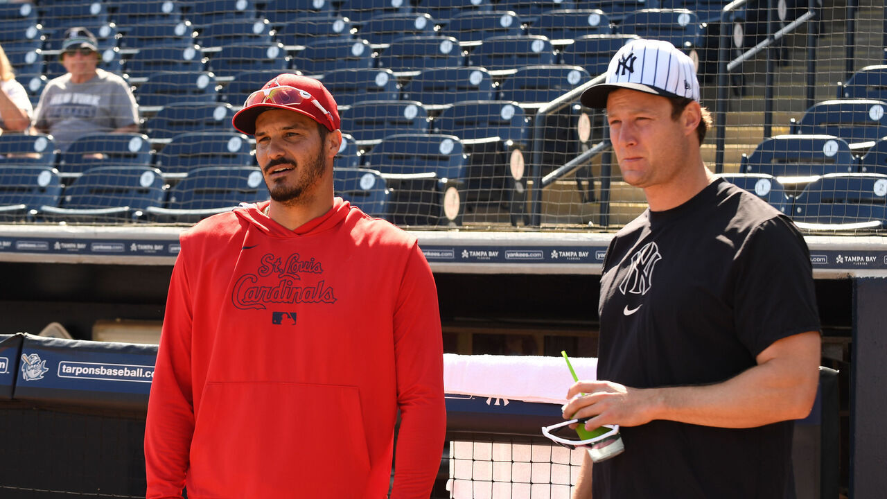 TAMPA, FLORIDA - FEBRUARY 26: Nolan Arenado #28 of the St. Louis Cardinals and Gerrit Cole #45 of the New Yankees chat before a spring training game at George M. Steinbrenner Field on February 26, 2025 in Tampa, Florida.