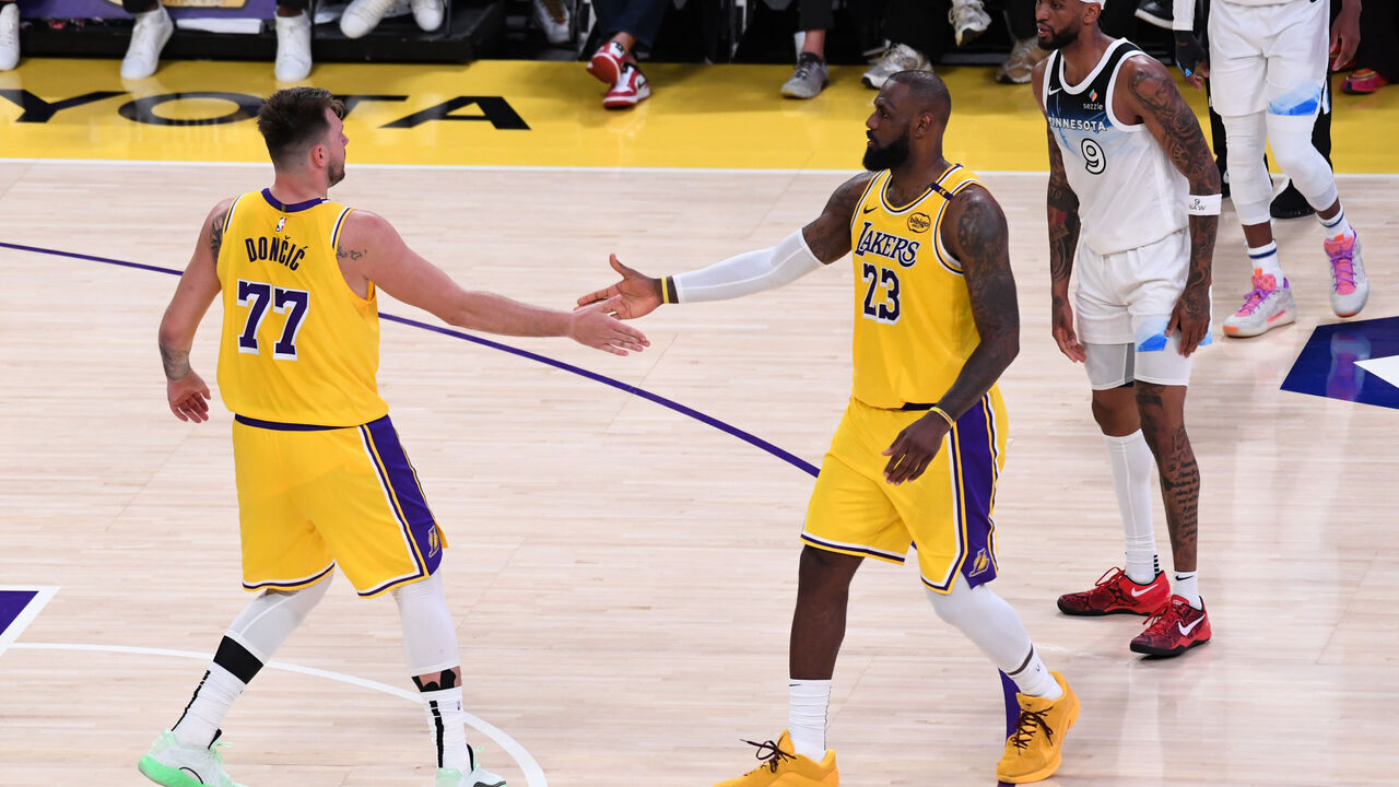 LOS ANGELES, CA - FEBRUARY 27: Luka Doncic #77 high fives LeBron James #23 of the Los Angeles Lakers during the game against the Minnesota Timberwolves on February 27, 2025 at Crypto.Com Arena in Los Angeles, California. NOTE TO USER: User expressly acknowledges and agrees that, by downloading and/or using this Photograph, user is consenting to the terms and conditions of the Getty Images License Agreement. Mandatory Copyright Notice: Copyright 2025 NBAE