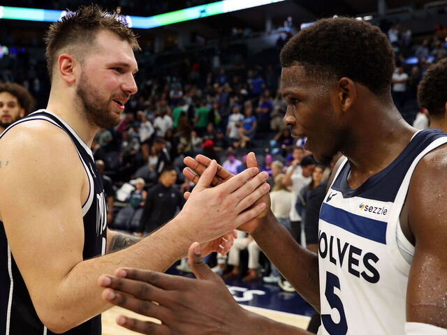MINNEAPOLIS, MINNESOTA - OCTOBER 29: Luka Doncic #77 of the Dallas Mavericks and Anthony Edwards #5 of the Minnesota Timberwolves shake hands after the game at Target Center on October 29, 2024 in Minneapolis, Minnesota. The Mavericks defeated the Timberwolves 120-114.