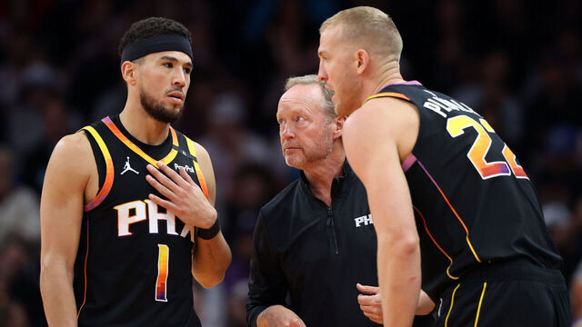 PHOENIX, ARIZONA - DECEMBER 03: Head coach Mike Budenholzer of the Phoenix Suns talks with Devin Booker #1 and Mason Plumlee #22 during the second half of the Emirates NBA Cup game against the San Antonio Spurs at Footprint Center on December 03, 2024 in Phoenix, Arizona. The Suns defeated the Spurs 104-93.