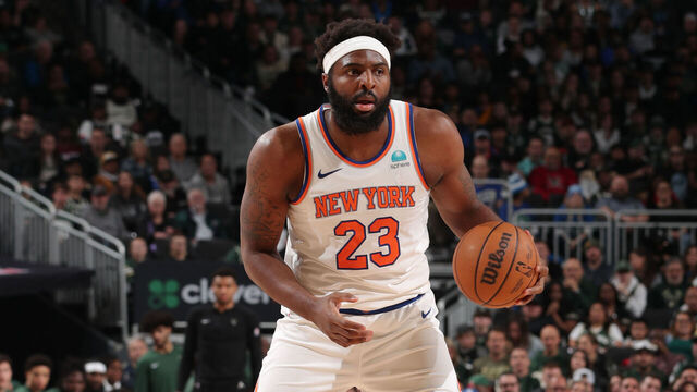 MILWAUKEE, WI - APRIL 7: Mitchell Robinson #23 of the New York Knicks handles the ball during the game against the Milwaukee Bucks on April 7, 2024 at the Fiserv Forum Center in Milwaukee, Wisconsin. Mandatory Copyright Notice: Copyright 2024 NBAE .