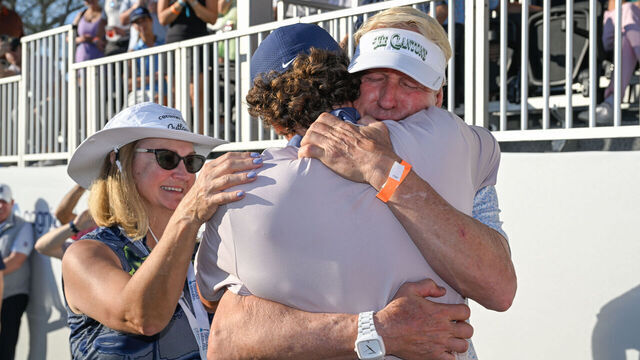 PALM BEACH GARDENS, FLORIDA - FEBRUARY 28: Luke Clanton hugs his father, David Clanton, near the 18th green after earning his PGA TOUR card during the second round of The Cognizant Classic in The Palm Beaches at PGA National Resort the Champion Course on February 28, 2025 in Palm Beach Gardens, Florida.