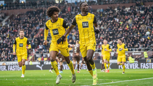 HAMBURG, GERMANY - MARCH 01: Serhou Guirassy of Borussia Dortmund celebrates with teammate Karim Adeyemi of Borussia Dortmund after scoring his team's first goal during the Bundesliga match between FC St. Pauli 1910 and Borussia Dortmund at Millerntor Stadium on March 01, 2025 in Hamburg, Germany.