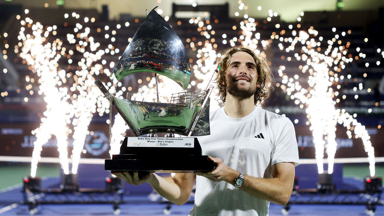 DUBAI, UNITED ARAB EMIRATES - MARCH 01: Stefanos Tsitsipas of Greece celebrates with the trophy after victory over Felix Auger-Aliassime of Canada in the final during day fourteen of the Dubai Duty Free Tennis Championships at Dubai Duty Free Tennis Stadium on March 01, 2025 in Dubai, United Arab Emirates.