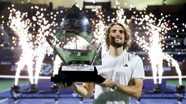 DUBAI, UNITED ARAB EMIRATES - MARCH 01: Stefanos Tsitsipas of Greece celebrates with the trophy after victory over Felix Auger-Aliassime of Canada in the final during day fourteen of the Dubai Duty Free Tennis Championships at Dubai Duty Free Tennis Stadium on March 01, 2025 in Dubai, United Arab Emirates.