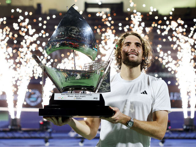 DUBAI, UNITED ARAB EMIRATES - MARCH 01: Stefanos Tsitsipas of Greece celebrates with the trophy after victory over Felix Auger-Aliassime of Canada in the final during day fourteen of the Dubai Duty Free Tennis Championships at Dubai Duty Free Tennis Stadium on March 01, 2025 in Dubai, United Arab Emirates.