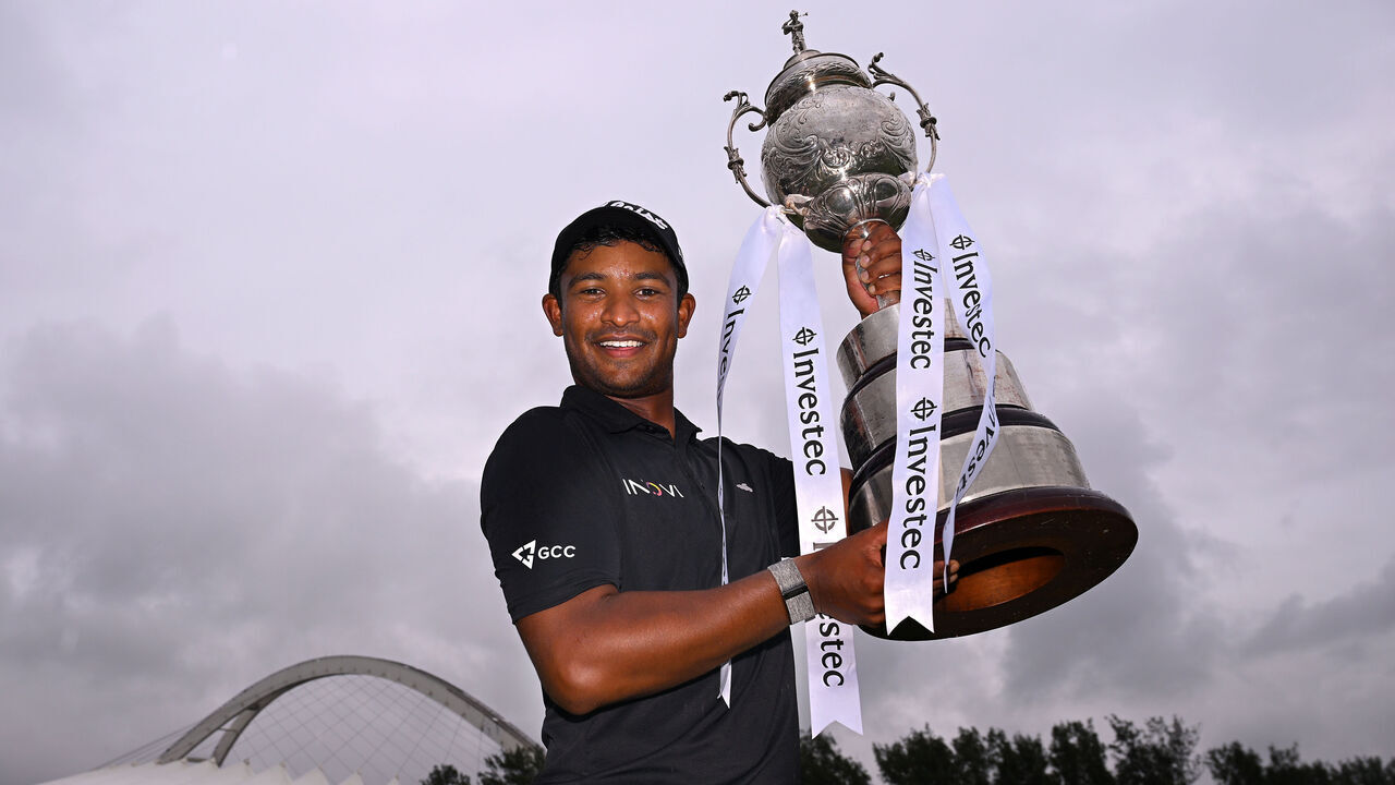 DURBAN, SOUTH AFRICA - MARCH 02: Dylan Naidoo of South Africa celebrates victory with the trophy following a play off against Laurie Canter of England on the 18th hole on day four of the Investec South African Open Championship 2025 at Durban Country Club on March 02, 2025 in Durban, South Africa.