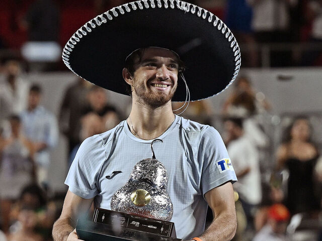 Czech Republic's Tomas Machac holds up the trophy after beating Spain's Alejandro Davidovich Fokina during their 2025 Mexico ATP Open 500 men´s singles tennis final match at the Arena GNP Seguros in Acapulco, Guerrero State, Mexico on March 1, 2025.