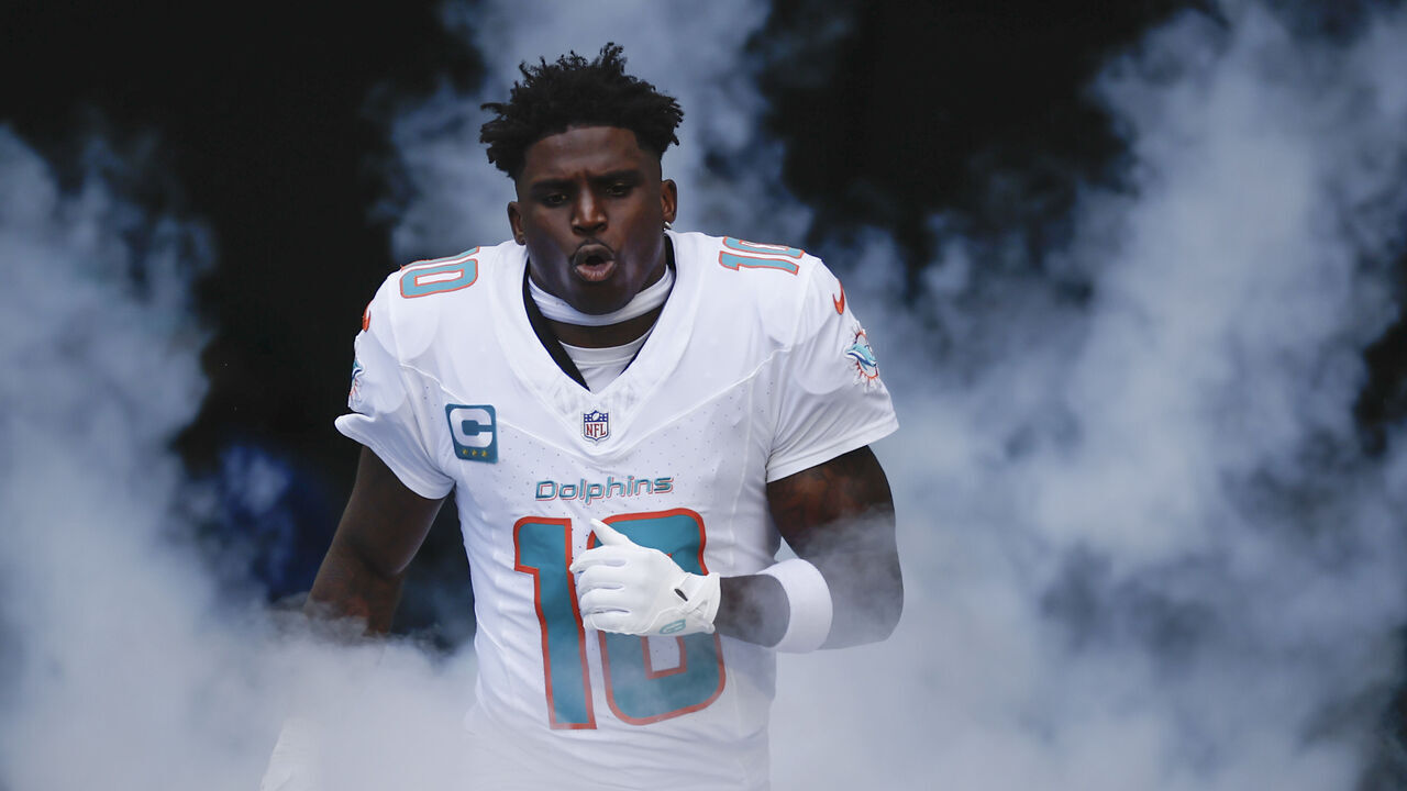 MIAMI GARDENS, FL - NOVEMBER 24: Miami Dolphins wide receiver Tyreek Hill (10) runs out on the field before the game between the Miami Dolphins and the New England Patriots on November 24, 2024 at Hard Rock Stadium in Miami Gardens, Fl.
