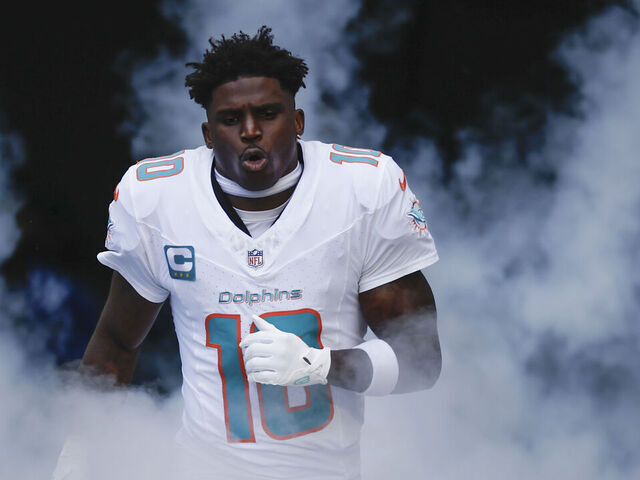 MIAMI GARDENS, FL - NOVEMBER 24: Miami Dolphins wide receiver Tyreek Hill (10) runs out on the field before the game between the Miami Dolphins and the New England Patriots on November 24, 2024 at Hard Rock Stadium in Miami Gardens, Fl.