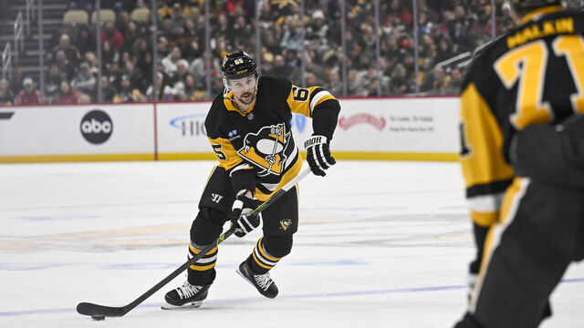 PITTSBURGH, PA - FEBRUARY 22: Pittsburgh Penguins defenseman Erik Karlsson (65) passes the puck during the first period in the NHL game between the Pittsburgh Penguins and the Washington Capitals on February 22, 2025, at PPG Paints Arena in Pittsburgh, PA.