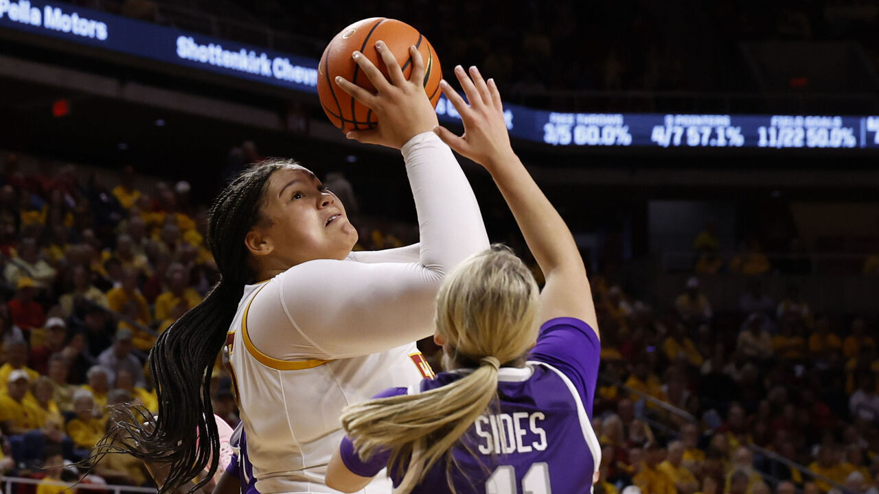 AMES, IA - MARCH 2: Audi Crooks #55 of the Iowa State Cyclones takes a shot as Taryn Sides #11 of the Kansas State Wildcats blocks in the first half of play at Hilton Coliseum on March 2, 2025, in Ames, Iowa.