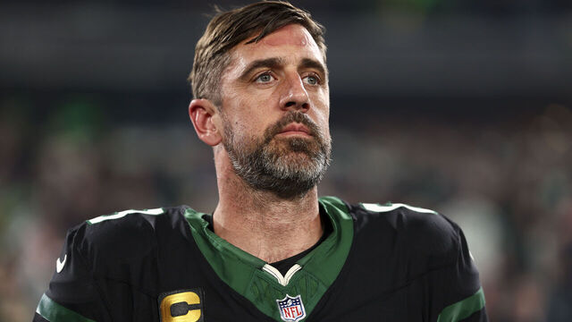 EAST RUTHERFORD, NEW JERSEY - OCTOBER 31: Aaron Rodgers #8 of the New York Jets stands on the sidelines during the national anthem prior to an NFL football game against the Houston Texans, Thursday at MetLife Stadium on October 31, 2024 in East Rutherford, NJ.