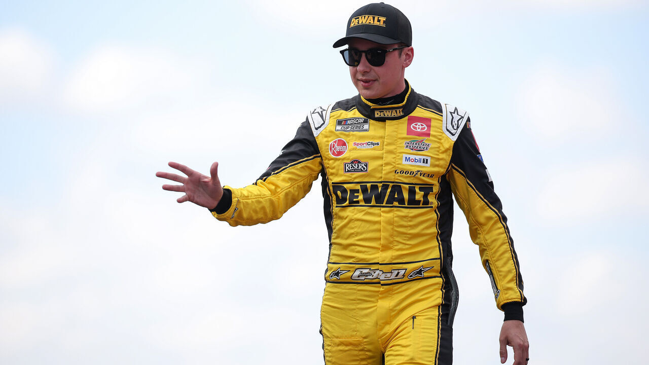 AUSTIN, TEXAS - MARCH 02: Christopher Bell, driver of the #20 DEWALT Toyota, waves to fans as he walks onstage during driver intros prior to the NASCAR Cup Series EchoPark Automotive Grand Prix at Circuit of The Americas on March 02, 2025 in Austin, Texas.
