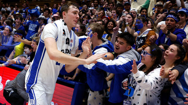 DURHAM, NORTH CAROLINA - MARCH 3: Cooper Flagg #2 of the Duke Blue Devils high-fives fans following their 93-60 victory against the Wake Forest Demon Deacons at Cameron Indoor Stadium on March 3, 2025 in Durham, North Carolina.