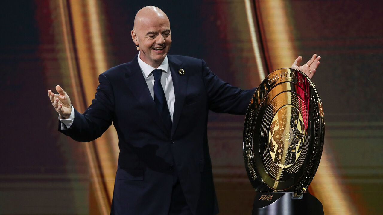 MIAMI, FLORIDA - DECEMBER 05: FIFA President Gianni Infantino presents The FIFA Club World Cup Trophy during the 2025 FIFA Club World Cup Draw at Telemundo Studios on December 05, 2024 in Miami, Florida.
