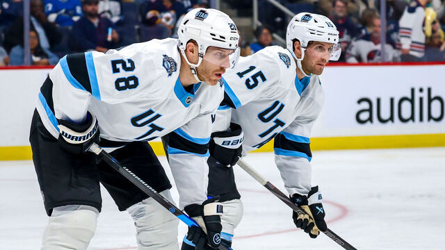 WINNIPEG, CANADA - NOVEMBER 05: Ian Cole #28 and Alexander Kerfoot #15 of the Utah Hockey Club prepare for a second period face-off against the Winnipeg Jets at Canada Life Centre on November 05, 2024 in Winnipeg, Manitoba, Canada.