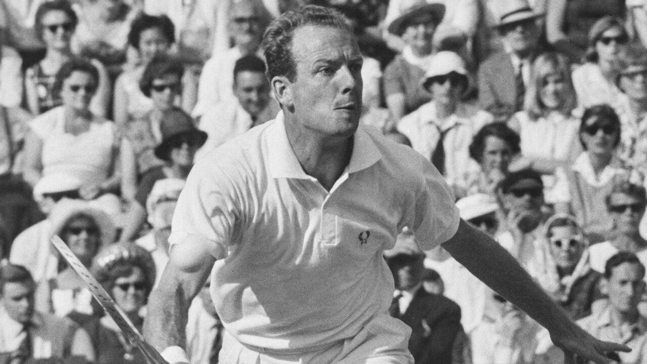 Fred Stolle of Australia plays a forehand return against Rafael Osuna of Mexico during their Men's Singles Quarter Final Round match on Centre Court at the Wimbledon Lawn Tennis Championship on 28th June 1965 at the All England Lawn Tennis and Croquet Club in Wimbledon in London, England. Fred Stolle won the match 11 - 13, 6 - 3, 6 - 1, 6 - 2. ( Photo by Dennis Oulds/Central Press/Hulton Archive/Getty Images )