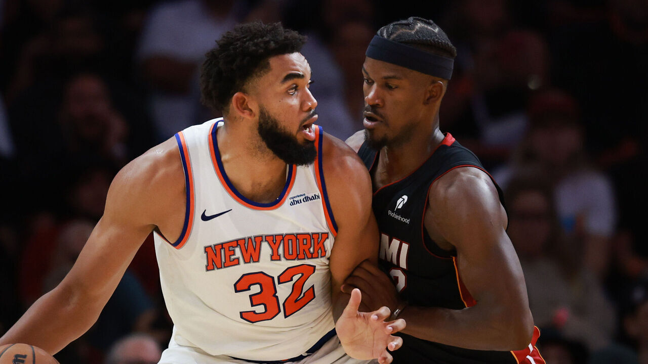 MIAMI, FLORIDA - OCTOBER 30: Jimmy Butler #22 of the Miami Heat defends against Karl-Anthony Towns #32 of the New York Knicks during the second half at Kaseya Center on October 30, 2024 in Miami, Florida.