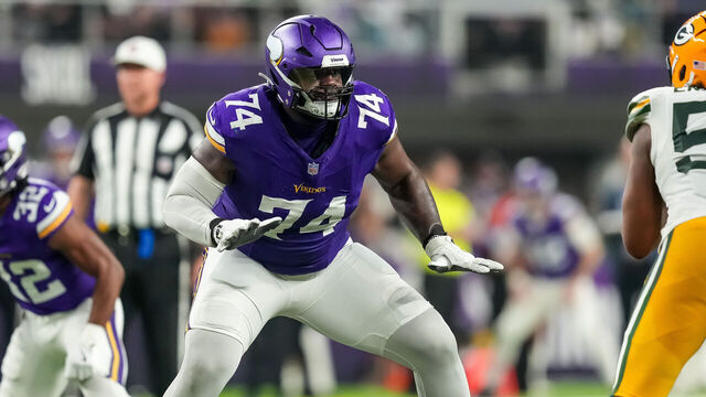 MINNEAPOLIS, MINNESOTA - DECEMBER 29: Cam Robinson #74 of the Minnesota Vikings blocks during a game between the Minnesota Vikings and Green Bay Packers at U.S. Bank Stadium on December 29, 2024 in Minneapolis, Minnesota.