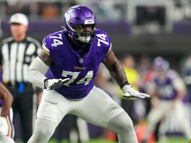 MINNEAPOLIS, MINNESOTA - DECEMBER 29: Cam Robinson #74 of the Minnesota Vikings blocks during a game between the Minnesota Vikings and Green Bay Packers at U.S. Bank Stadium on December 29, 2024 in Minneapolis, Minnesota.