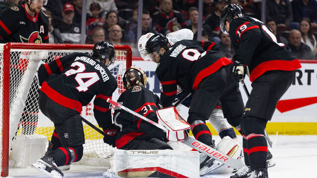 OTTAWA, ON - FEBRUARY 13: Ottawa Senators Goalie Anton Forsberg (31) has the puck under him as Defenceman Jacob Bernard-Docker (24), Center Josh Norris (9), Right Wing Drake Batherson (19) and Columbus Blue Jackets Center Dmitri Voronkov (10) look for it during second period National Hockey League action between the Columbus Blue Jackets and Ottawa Senators on February 13, 2024, at Canadian Tire Centre in Ottawa, ON, Canada.