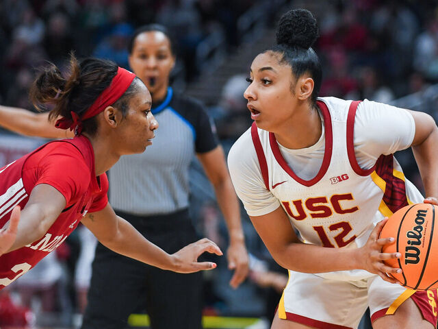 INDIANAPOLIS, INDIANA - MARCH 07: JuJu Watkins #12 of the USC Trojans looks to make a play against Chloe Moore-McNeil #22 of the Indiana Hoosiers during the second half of the quarterfinal round of the Big Ten Women’s Basketball Tournament against at Gainbridge Fieldhouse on March 07, 2025 in Indianapolis, Indiana. The USC Trojans won the game 84-79.