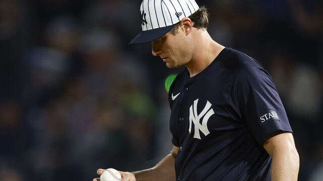 TAMPA, FLORIDA - FEBRUARY 28: Gerrit Cole #45 of the New York Yankees inspects a baseball in the third inning during a spring training game against the Toronto Blue Jays at George M. Steinbrenner Field on February 28, 2025 in Tampa, Florida.