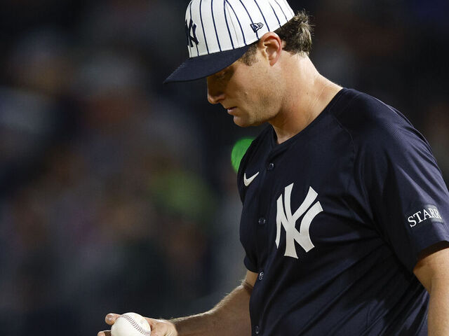 TAMPA, FLORIDA - FEBRUARY 28: Gerrit Cole #45 of the New York Yankees inspects a baseball in the third inning during a spring training game against the Toronto Blue Jays at George M. Steinbrenner Field on February 28, 2025 in Tampa, Florida.
