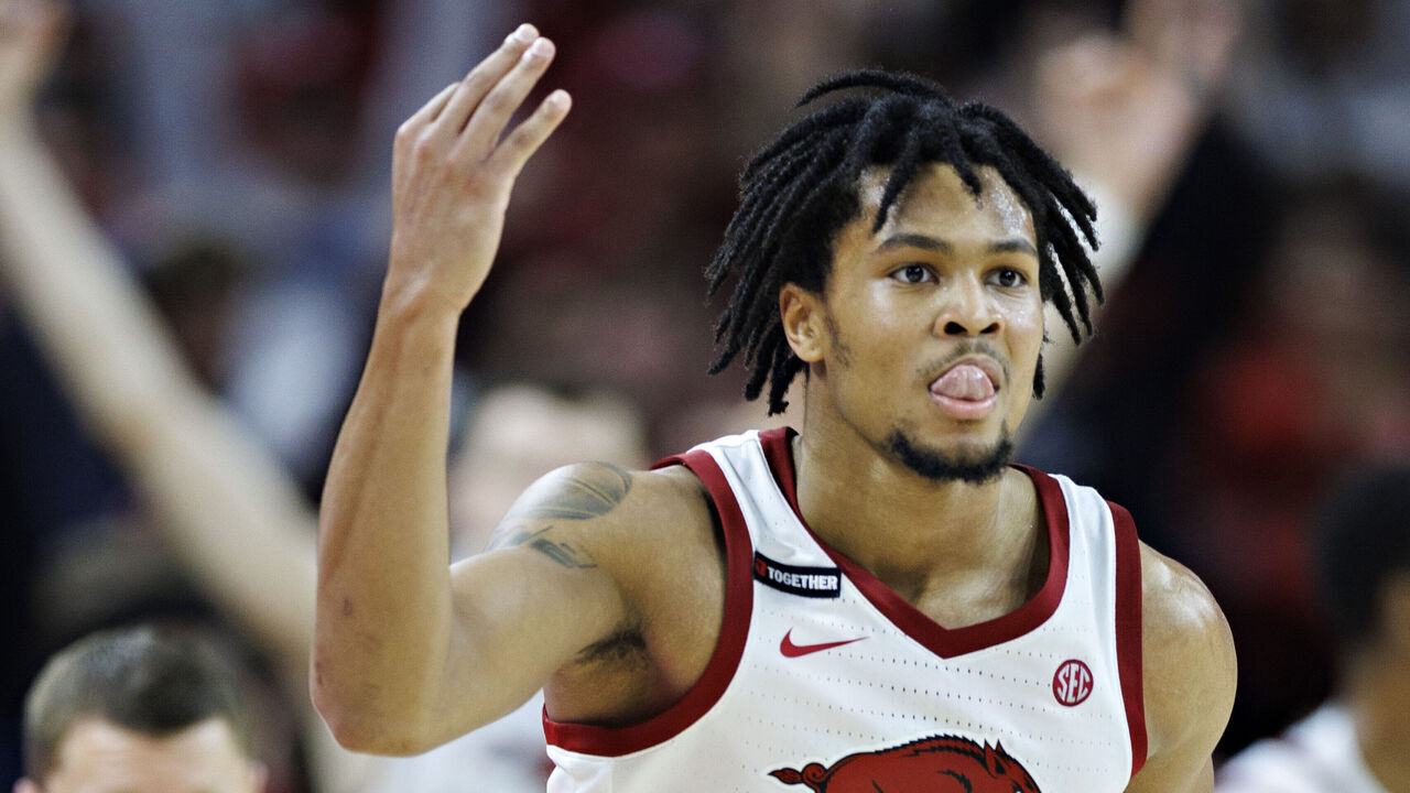 FAYETTEVILLE, ARKANSAS - MARCH 08: D.J. Wagner #21 of the Arkansas Razorbacks celebrates after hitting a three pointer in the second half during a game against the Mississippi State Bulldogs at Bud Walton Arena on March 08, 2025 in Fayetteville, Arkansas. The Razorbacks defeated the Bulldogs 93-92.