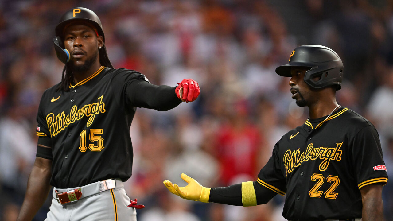 CLEVELAND, OHIO - AUGUST 31: Oneil Cruz #15 and Andrew McCutchen #22 of the Pittsburgh Pirates walk off the field during the seventh inning against the Cleveland Guardians at Progressive Field on August 31, 2024 in Cleveland, Ohio.