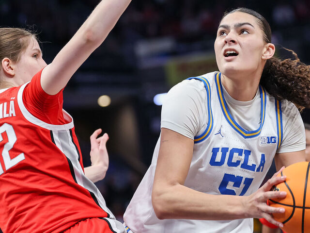 INDIANAPOLIS, INDIANA - MARCH 8: Lauren Betts #51 of the UCLA Bruins looks to shoot the ball against Elsa Lemmila #12 of the Ohio State Buckeyes during the second half in the Big Ten Women's Basketball Tournament semifinals at Gainbridge Fieldhouse on March 8, 2025 in Indianapolis, Indiana.