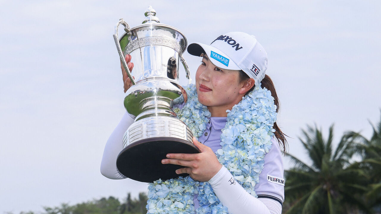 Japan's Rio Takeda holds the trophy after winning the LPGA Blue Bay golf tournament at the Jian Lake Blue Bay Golf Club in Lingshui, on China's southern Hainan island on March 9, 2025.
