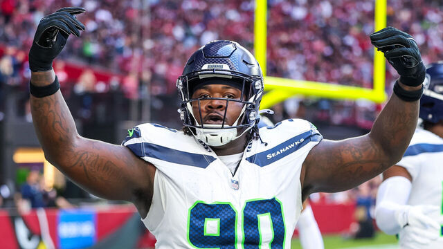 GLENDALE, ARIZONA - DECEMBER 8: Jarran Reed #90 of the Seattle Seahawks motions to the Seattle fans during the first quarter of a game against the Arizona Cardinals at State Farm Stadium on December 8, 2024 in Glendale, Arizona.