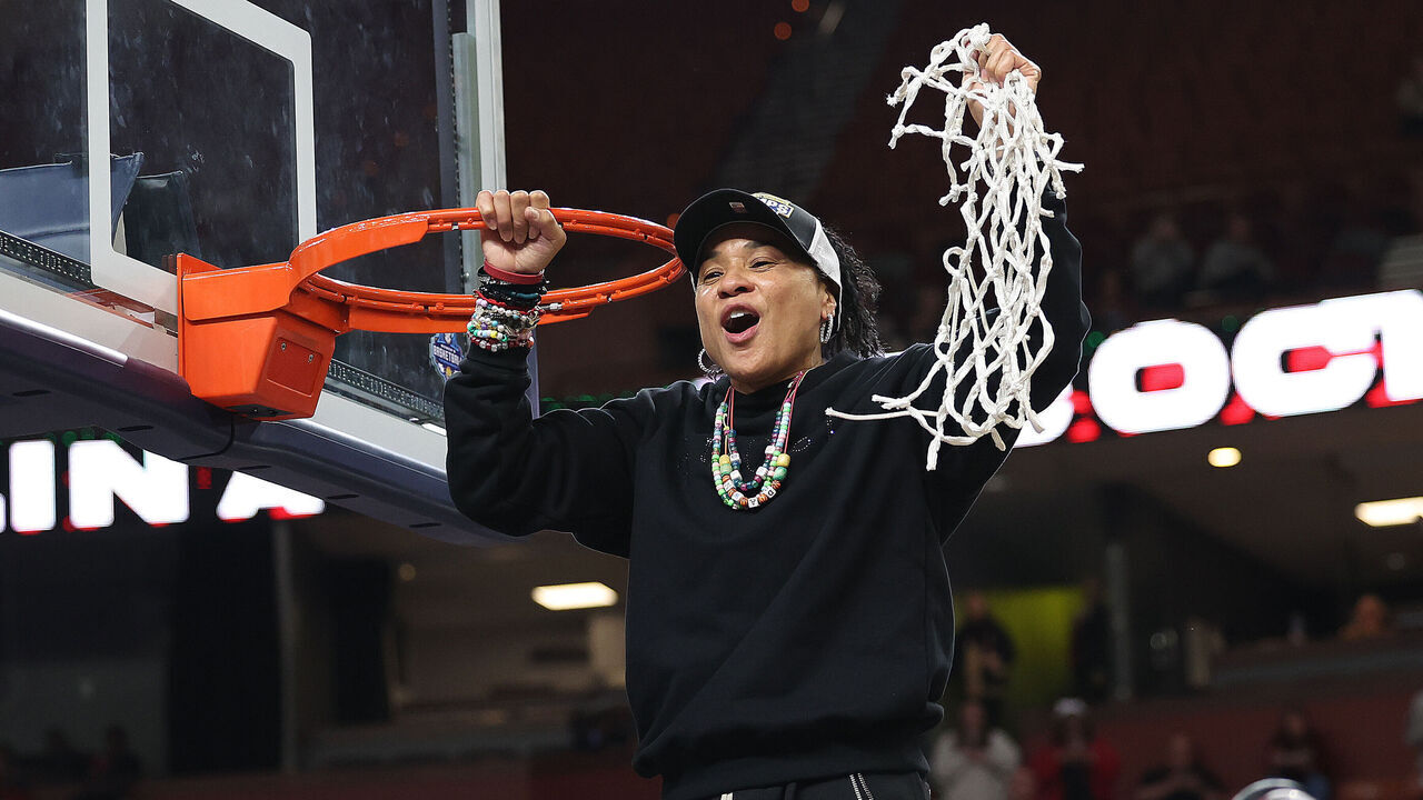 GREENVILLE, SC - MARCH 09: South Carolina Gamecocks head coach Dawn Staley holds up the net after cutting the last piece during the championship game of the SEC women's college basketball tournament between the Texas Longhorns and the South Carolina Gamecocks on March 9, 2025 at Bon Secours Wellness Arena in Greenville, S.C.