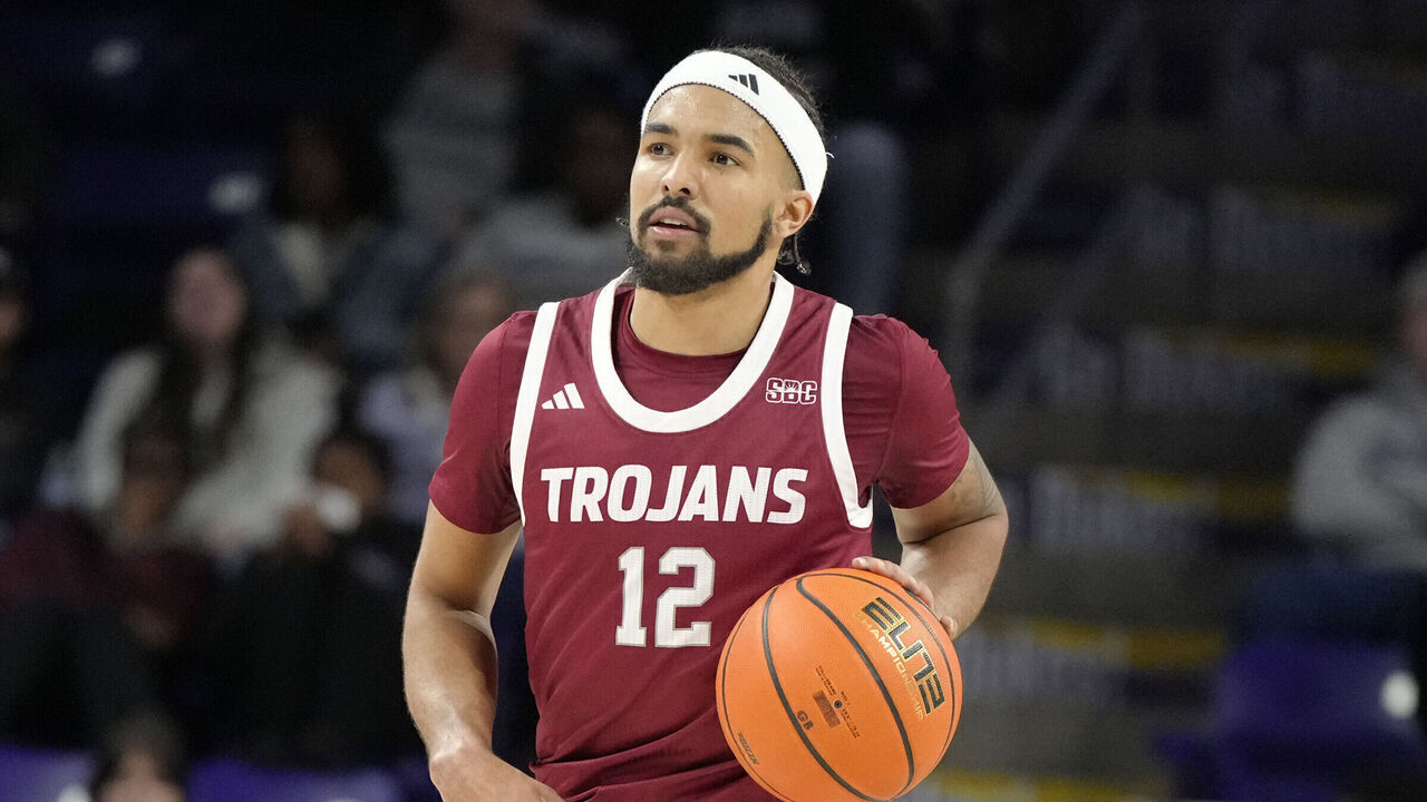 HARRISONBURG, VA - FEBRUARY 05: Tayton Conerway #12 of the Troy Trojans drives up court during a college basketball game against the James Madison Dukes at Atlantic Union Bank Arena on February 5, 2025 in Harrisonburg, Virginia.