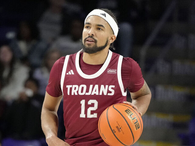 HARRISONBURG, VA - FEBRUARY 05: Tayton Conerway #12 of the Troy Trojans drives up court during a college basketball game against the James Madison Dukes at Atlantic Union Bank Arena on February 5, 2025 in Harrisonburg, Virginia.