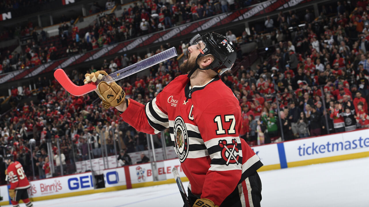 CHICAGO, ILLINOIS - MARCH 07: Nick Foligno #17 of the Chicago Blackhawks pretends to drink from a fans stick glass after defeating the Utah Hockey Club in overtime at the United Center on March 07, 2025 in Chicago, Illinois.