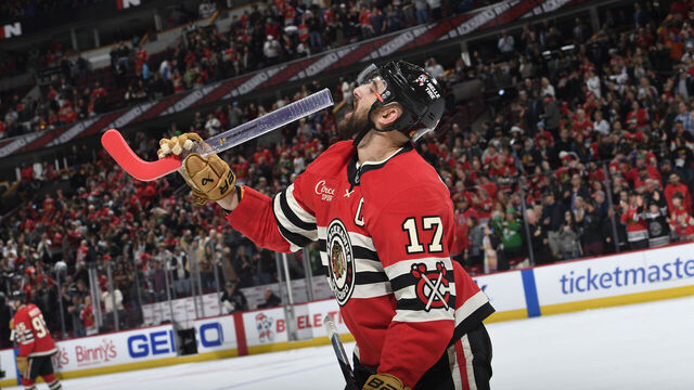 CHICAGO, ILLINOIS - MARCH 07: Nick Foligno #17 of the Chicago Blackhawks pretends to drink from a fans stick glass after defeating the Utah Hockey Club in overtime at the United Center on March 07, 2025 in Chicago, Illinois.