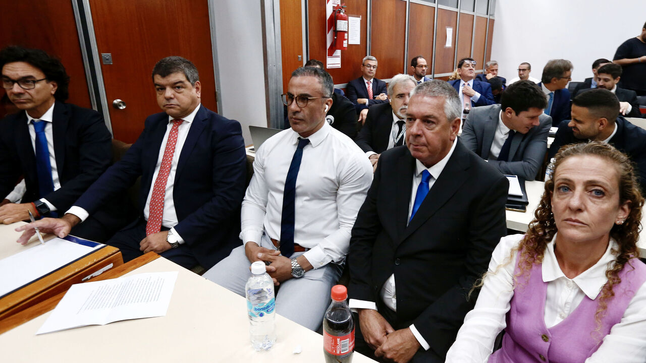 SAN ISIDRO, ARGENTINA - MARCH 11: Leopoldo Luque (C), former neurosurgeon of late Argentinian football legend Diego Armando Maradona, and his attorneys sit inside the courthouse on March 11, 2025 in San Isidro, Argentina. Maradona suffered a heart attack and died while recovering from a head surgery to remove a blood clot on November 25, 2020. Seven members of his medical staff have been accused of negligence and will face a trial under the charge of homicide.