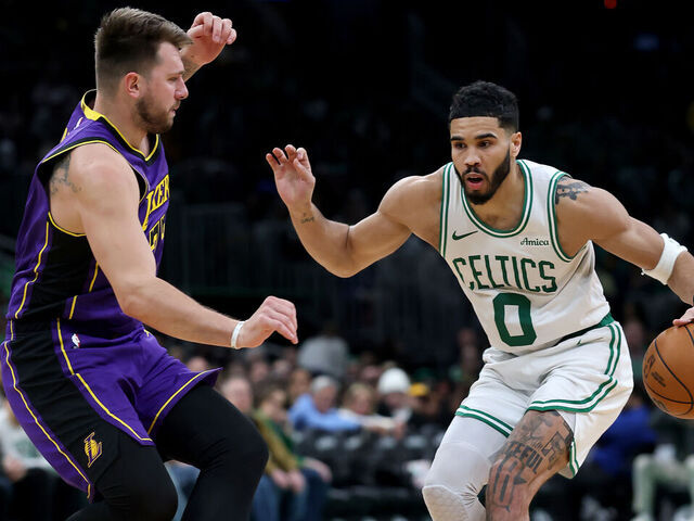 BOSTON, MASSACHUSETTS - MARCH 08: Jayson Tatum #0 of the Boston Celtics looks for the open lane as Luka Doncic #77 of the Los Angeles Lakers defends during the second half at TD Garden on March 08, 2025 in Boston, Massachusetts. The Boston Celtics defeated the Los Angeles Lakers 111-101.